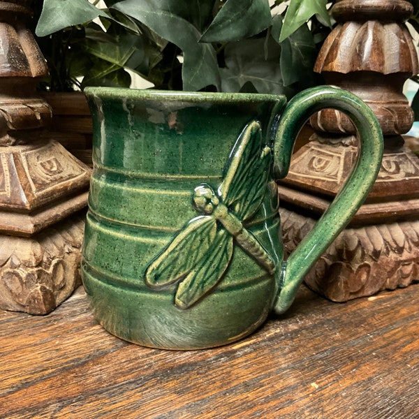 Holds 14 oz.  Handmade Dragonfly textured stoneware pottery coffee mug, tea cup.  Dishwasher and microwave safe.  Great gift.  Ready to ship