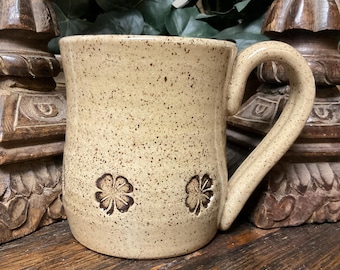 Hold 14 oz.  Handmade Four Leaf Clover stoneware pottery coffee mug, tea cup.  Microwave and dishwasher safe. Great gift. Ready to ship