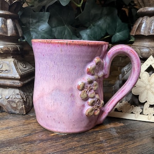 Holds 14 oz.  Handmade Rustic Flower pottery coffee mug, coffee cup, tea cup.  Microwave, dishwasher safe. Ready to ship. Great gift.