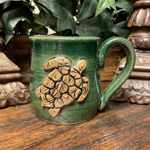 Holds 14 oz.  Handmade Turtle pottery coffee mug, coffee cup, tea cup.  Dishwasher and microwave safe.  Unique gift.  Ready to ship