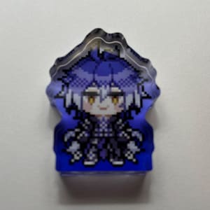 May include: A pixelated acrylic charm featuring a character with blue hair and yellow eyes. The charm has a blue gradient background and a unique, wavy edge. The character is dressed in black clothing.