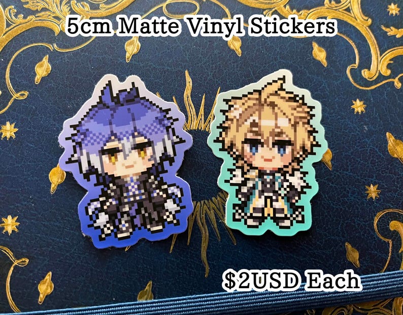 May include: Two 5cm matte vinyl stickers featuring pixelated anime-style characters. One has blue hair and the other has blonde hair. The stickers are on a dark blue surface with gold decorative accents.