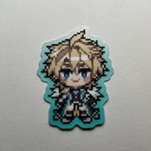 May include: A pixelated sticker featuring a character with blonde hair and blue eyes. The character is wearing a detailed outfit with black, white, and gold accents. The sticker has a light blue border and is set against a white background.