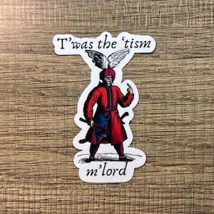 May include: A sticker featuring a vintage illustration of a man in a red coat, blue undershirt, and a feathered hat, holding two axes. The text "T'was the 'tism m'lord" is printed above and below the illustration.