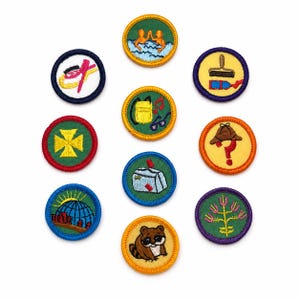 May include: A collection of ten circular embroidered merit badges featuring various designs including a swimmer, a paintbrush, a backpack, a detective hat with a question mark, a mailbox, a raccoon, a globe, a flower, and geometric shapes.
