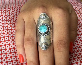 Made by hand sterling silver ring with blue Larimar stone. adorned with silver rosettes in the shield style ring band, southwestern style