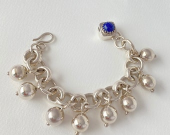 Bracelet made of fine silver links and sterling silver beads; clasp with lapis lazuli  Blue stone, bohemian elegant it feels substantial on.
