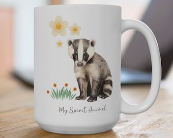May include: White ceramic mug with a badger illustration and the text "My Spirit Animal". The badger is sitting on a patch of green grass with yellow flowers.