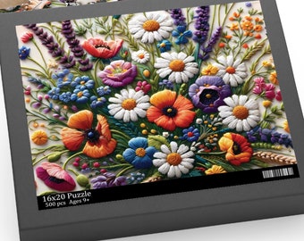 May include: A 500 piece jigsaw puzzle featuring a colorful embroidered floral bouquet with daisies, poppies, and other wildflowers. The box is black with a white border and the text "16x20 Puzzle 500 pcs Ages 9+"