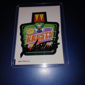 Dan Castellaneta autografou o cartão do palhaço Krusty com capa