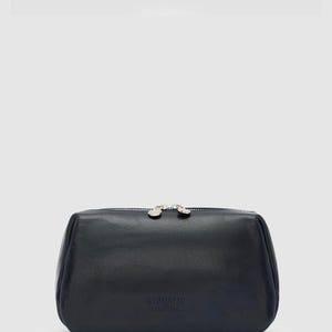 May include: Black leather cosmetic bag with dual silver zippers. The bag has a rectangular shape with rounded edges. The text "REPUBLIC FLORENCE" is embossed on the front.