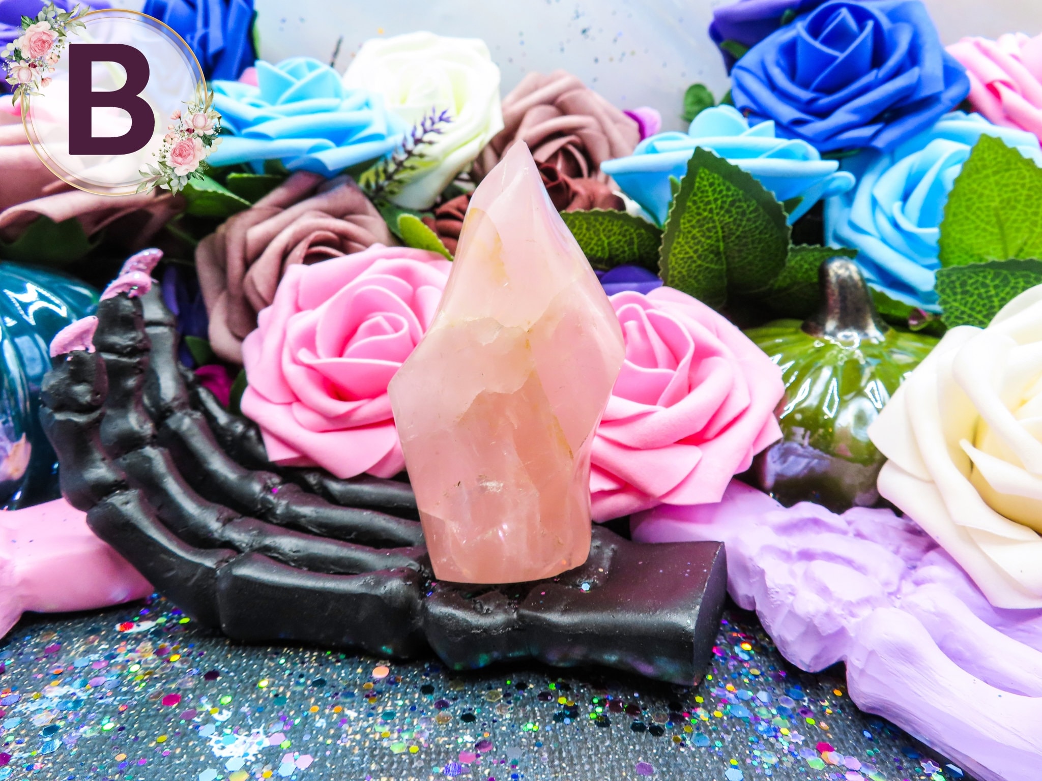 Beautiful rose quartz flame tower surrounded by roses – perfect for love spell aesthetics.