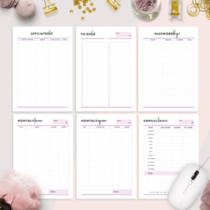May include: Printable planner pages with a purple and white color scheme. The pages include sections for affiliates, to-do lists, passwords, monthly income, monthly expenses, and annual finances.