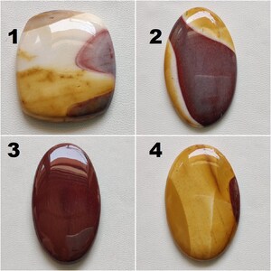 May include: Four polished oval and square shaped stones with different patterns of brown, red, white, and yellow colors. The stones are numbered 1 through 4.
