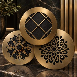 May include: Three circular brass vent covers with intricate cut-out patterns. The top cover features a diamond grid with small studs, the bottom left has a floral motif, and the bottom right displays a radial petal design, all over black mesh.