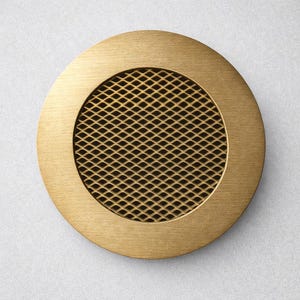 May include: A round, brass-colored metal vent cover with a diamond-patterned mesh center. The vent cover has a raised, circular border and a matte finish. The design is simple and modern, suitable for various interior styles.