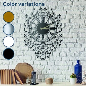 May include: Black metal wall clock with Roman numeral markings and intricate floral design. The clock is mounted on a white brick wall. Color variations are shown in the image: gold, silver, white, and black.
