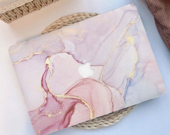May include: A pink and gold marble laptop skin with a subtle shimmer. The skin features a swirling pattern of pink, white, and gold, with a subtle shimmer. The skin is designed to fit a standard laptop.