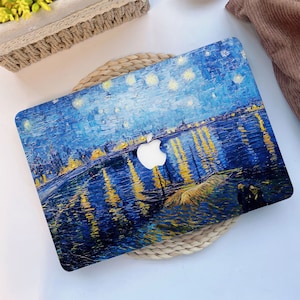 May include: A laptop skin with a blue and yellow starry night painting. The painting is a reproduction of Vincent van Gogh's famous artwork.