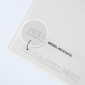 May include: Close-up of a white electronic device with the model number SY69JL and FCC and IC certification marks.
