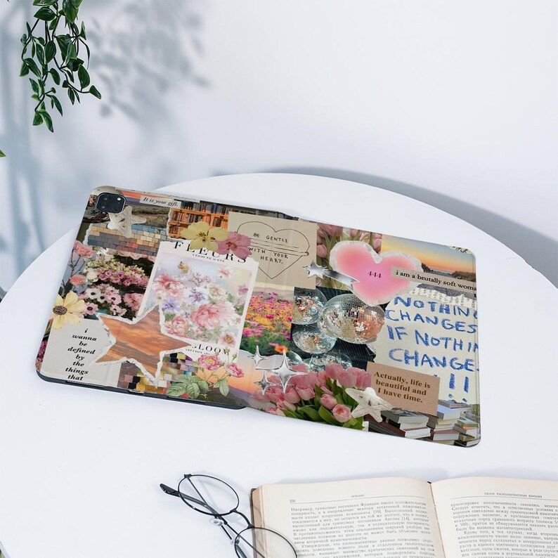 May include: A tablet case featuring a collage design with floral and star motifs. The case includes text that reads "FLEURS", "NOTHING CHANGES IF NOTHING CHANGE", and "Actually, life is beautiful and I have time."