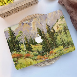 May include: A laptop skin with a colorful painting of a mountain landscape. The painting features a valley with trees and a mountain range in the background. The laptop skin has a white Apple logo in the center.