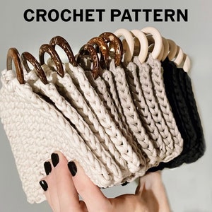 May include: A set of crocheted coasters with wooden rings. The coasters are beige and black. The wooden rings are brown.