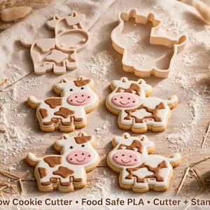 May include: Two light-colored plastic cow cookie cutters and four decorated cow-shaped sugar cookies with brown spots and pink snouts. The text Cow Cookie Cutter • Food Safe PLA • Cutter + Stamp is printed at the bottom of the image.