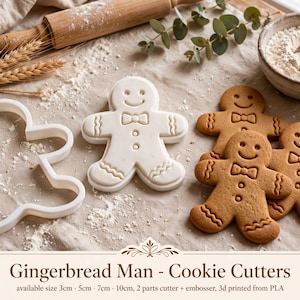 May include: A white plastic gingerbread man cookie cutter and matching embosser, accompanied by three baked gingerbread cookies. The text on the image reads: Gingerbread Man - Cookie Cutters, available size 3cm, 5cm, 7cm, 10cm, 2 parts cutter + embosser, 3d printed from PLA.