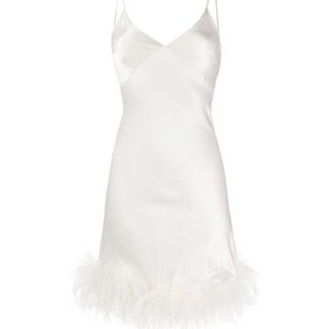 May include: A white slip dress with a feather trim. The dress has thin straps and a v-neckline.
