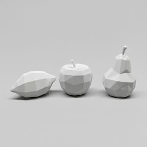 May include: Three white geometric fruit sculptures: a lemon, an apple, and a pear. The sculptures have a faceted design, giving them a modern, minimalist aesthetic. The fruit are arranged on a plain, light grey background.