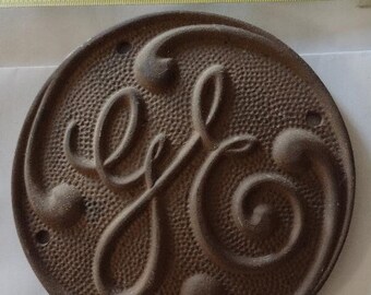 Bronze &quot;GE&quot; circular I.D. name plate from a power generating boiler in New York state.