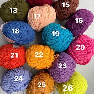 May include: A collection of 26 balls of yarn in various colors, including red, orange, yellow, green, blue, purple, pink, and brown. Each ball is numbered from 13 to 26.
