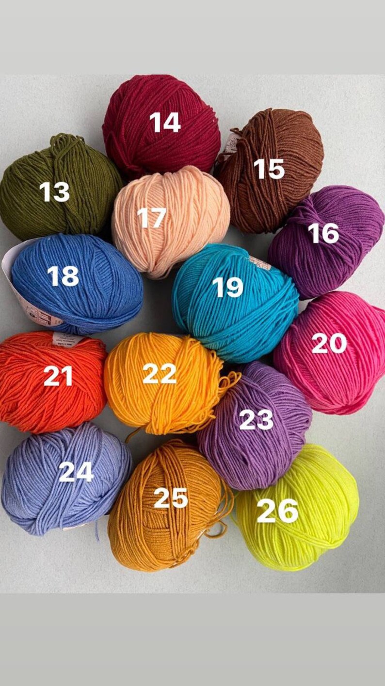 May include: A collection of 26 balls of yarn in various colors, including red, orange, yellow, green, blue, purple, pink, and brown. Each ball is numbered from 13 to 26.
