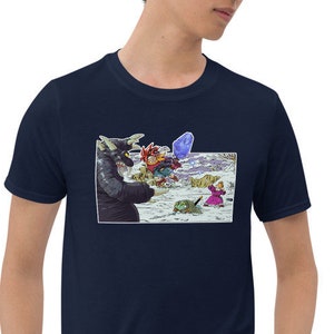 May include: A navy blue t-shirt with a graphic print of a cartoon monster with a blue and purple background. The monster is holding a red and yellow object.