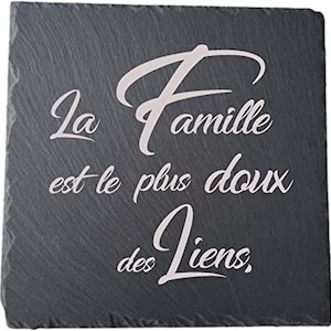 May include: Black slate coaster with white text that reads "La famille est le plus doux des liens."