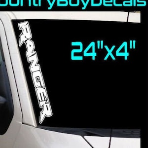 May include: White vinyl decal with the word "RANGER" in a stylized font. The decal is 24 inches by 4 inches. The decal is shown on a car windshield. The text "TRACKING INCLUDED ON EVERY PURCHASE" and "30+ Colors Available" is also shown.