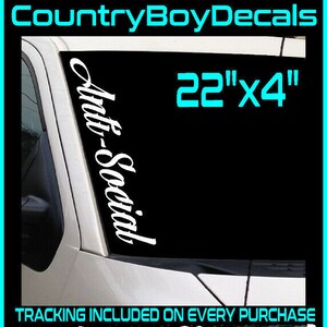 May include: White "Anti-Social" decal for a vehicle window, measuring 22" x 4". The decal is displayed on a black background, with the text "Anti-Social" in a stylish font. The image also includes the text "30+ Colors Available".