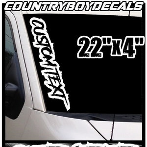 May include: White vinyl decal with the text "CUSTOMITEXT" in a stylized font. The decal is 22 inches by 4 inches and is shown on a black car windshield. The decal is available in over 40 colors.