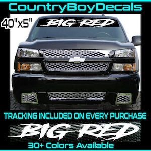 May include: A black truck with a white "BIG RED" windshield banner. The banner is 40 inches by 5 inches. The truck has a chrome grille and headlights. The text "TRACKING INCLUDED ON EVERY PURCHASE" and "30+ Colors Available" are also visible.