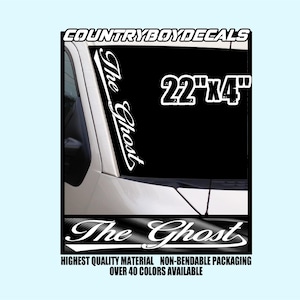 May include: White vinyl decal with the text "The Ghost" in a cursive font. The decal is 22 inches by 4 inches and is shown on a car windscreen. The decal is available in over 40 colours.