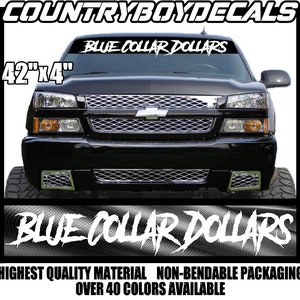 May include: A black truck with a white windshield banner that reads "BLUE COLLAR DOLLARS" in a bold, stylized font. The banner is 42 inches by 4 inches. The truck is in front of a black and white checkered background.