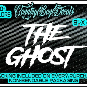 May include: White vinyl decal featuring the text "THE GHOST" in a bold, stylised font. The decal measures 8 inches by 4 inches and is displayed against a black and white carbon fibre background. Over 30 colours are available. Tracking is included with every purchase. Non-bendable packaging.