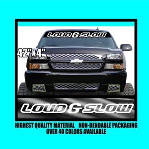 May include: Black truck with a windshield banner that reads "LOUD & SLOW" in white. The banner measures 42" x 4". The image also includes the text "HIGHEST QUALITY MATERIAL NON-BENDABLE PACKAGING OVER 40 COLORS AVAILABLE".
