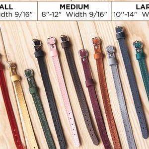 May include: A variety of leather camera straps in different colors and sizes. The straps are shown laid out on a wooden surface. The straps are available in small, medium, and large sizes. The straps are 9/16 inches wide.