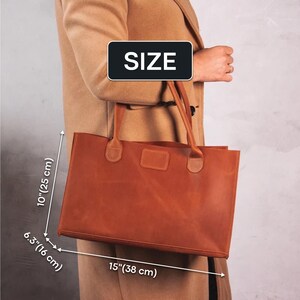May include: A brown leather tote bag with two handles. The bag measures 15 inches wide by 10 inches tall by 6.3 inches deep.