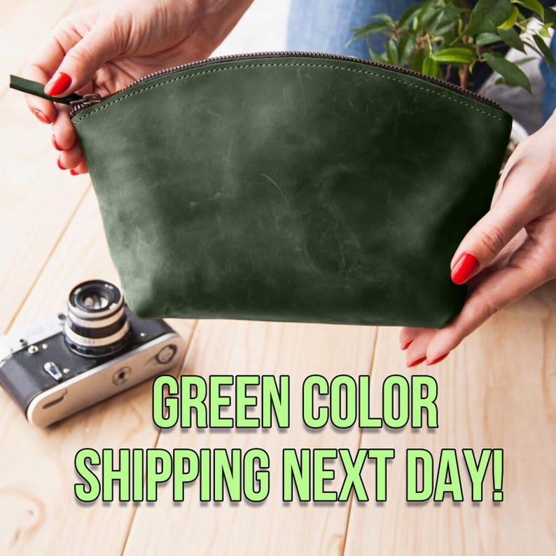 May include: A dark green leather zippered pouch or cosmetic bag. The bag is held in a person's hands. The text "GREEN COLOR SHIPPING NEXT DAY!" is below the bag.