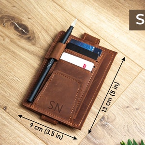 May include: A brown leather wallet with a pen holder, card slots, and a pocket for cash. The wallet measures 9 cm (3.5 in) by 13 cm (5 in).