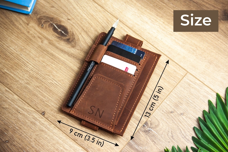 May include: A brown leather wallet with a pen holder, card slots, and a pocket for cash. The wallet measures 9 cm (3.5 in) by 13 cm (5 in).