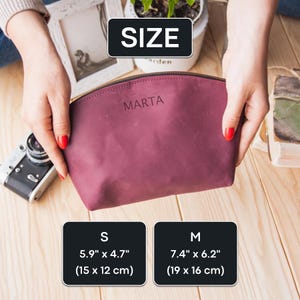 May include: A burgundy leather cosmetic bag with the name "MARTA" embossed on the front. The bag is available in two sizes: small (5.9" x 4.7", 15 x 12 cm) and medium (7.4" x 6.2", 19 x 16 cm).